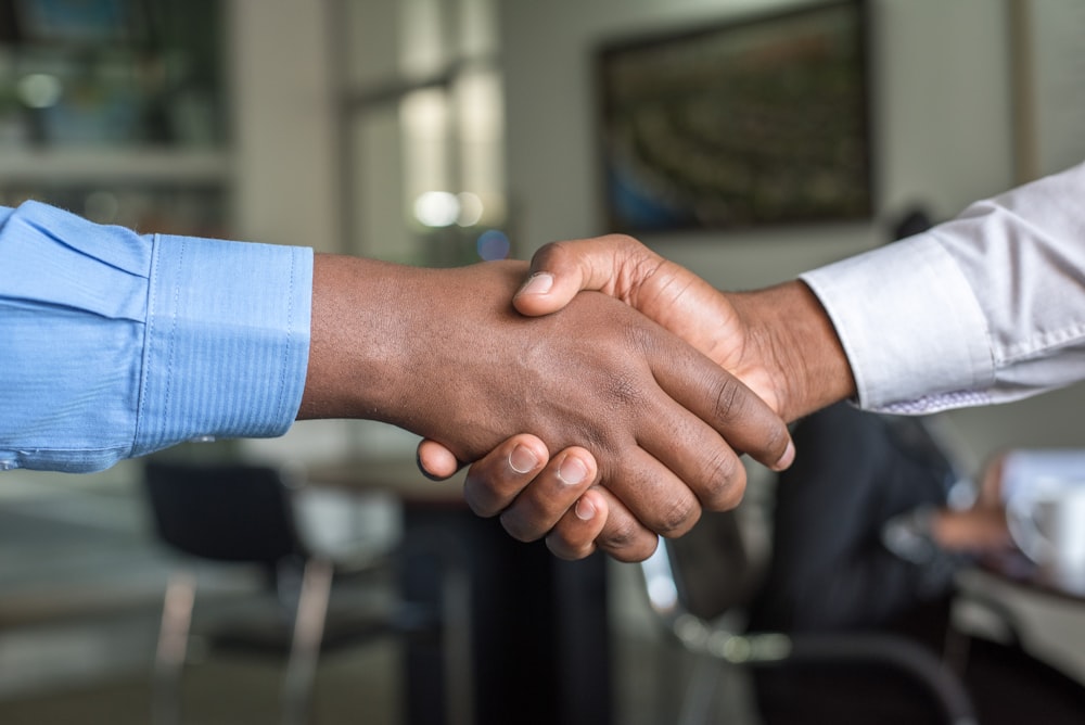 Insurance broker and client shaking hands after finding better cover in Gauteng